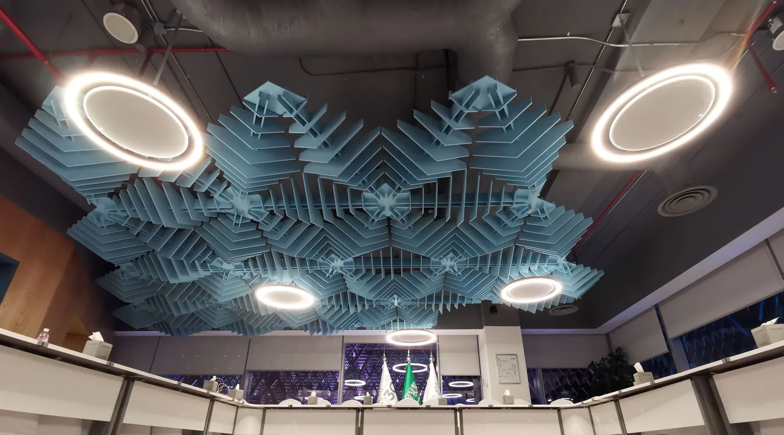 Boardroom with a sculpted acoustic ceiling above a U-shaped table