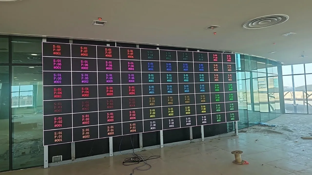LED wall showing a cabinet identification test pattern in a glass hall