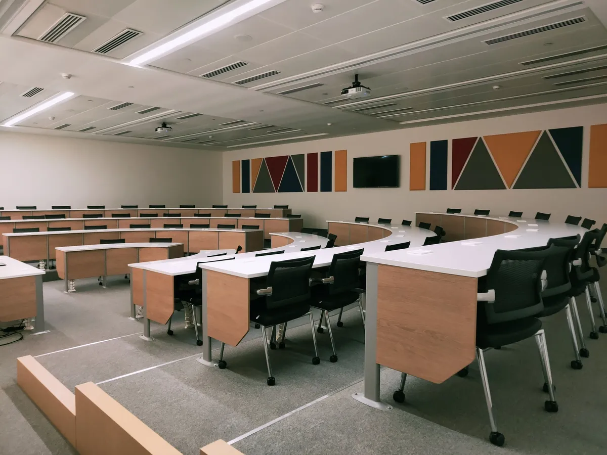 Classroom with curved desks and projection screens