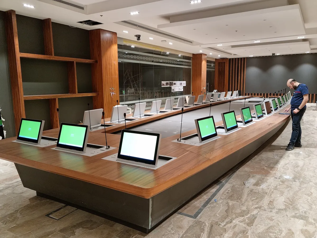 Board table with lift-up monitors and delegate units