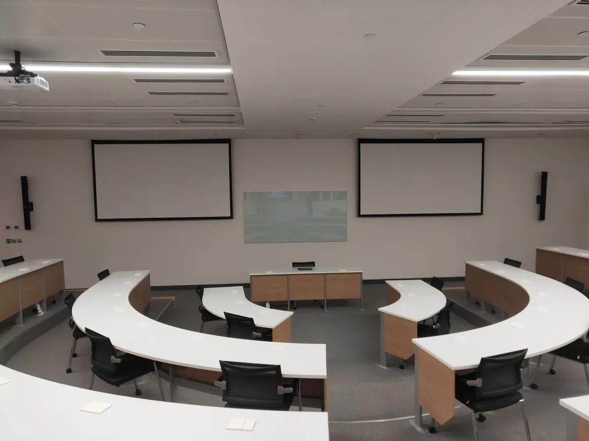Classroom with curved desks facing the front wall