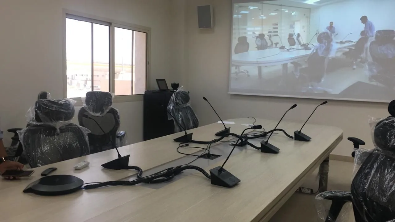 Meeting room with delegate microphones on the table