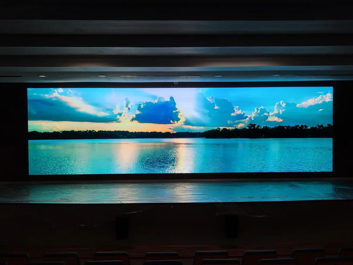 The auditorium LED wall displaying a lake scene above the stage