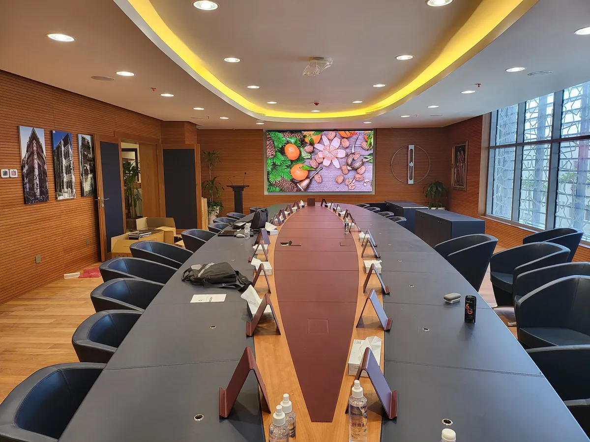 Boardroom with a long conference table and an LED wall