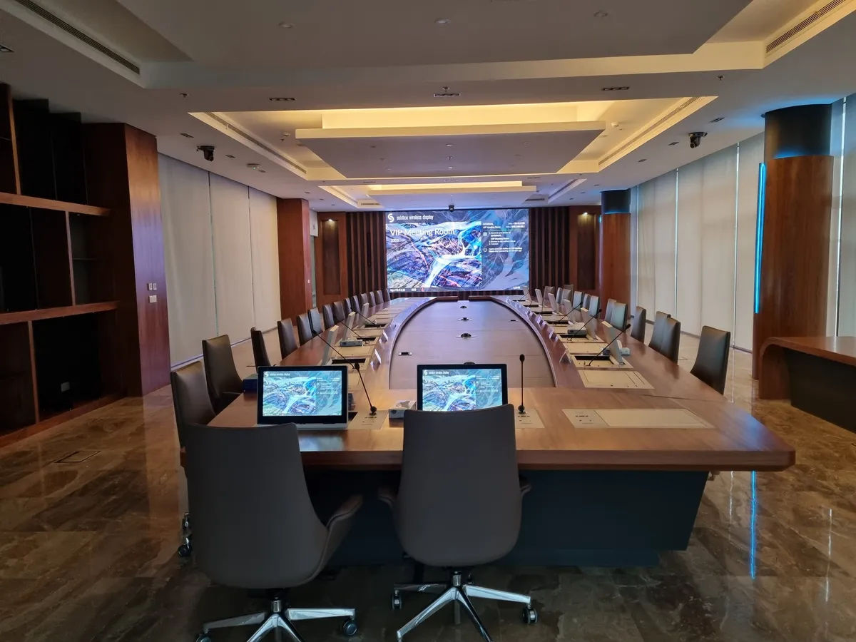 Board room with a wall of vertical slats and an LED display