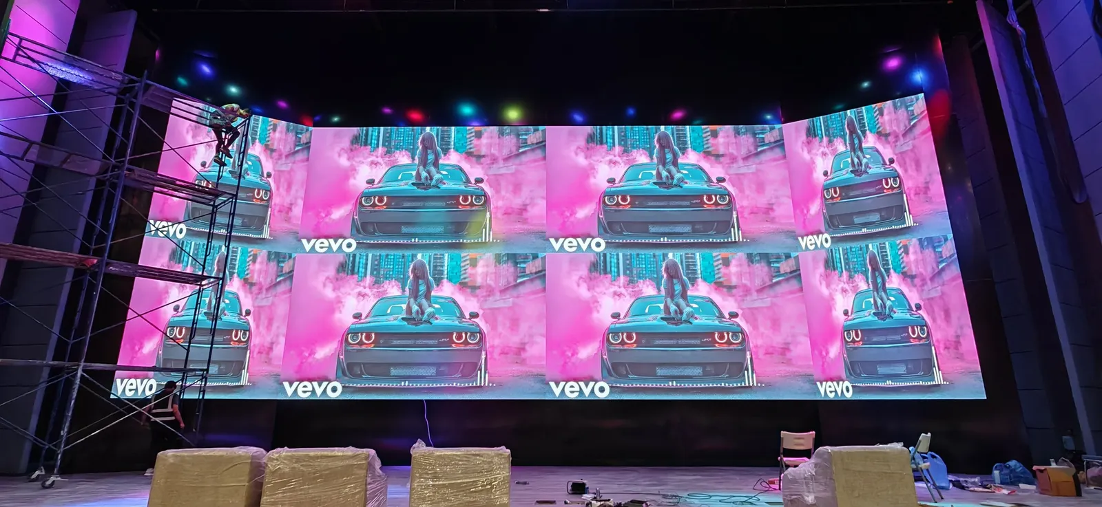 Curved LED wall above the auditorium stage, switched on with video content