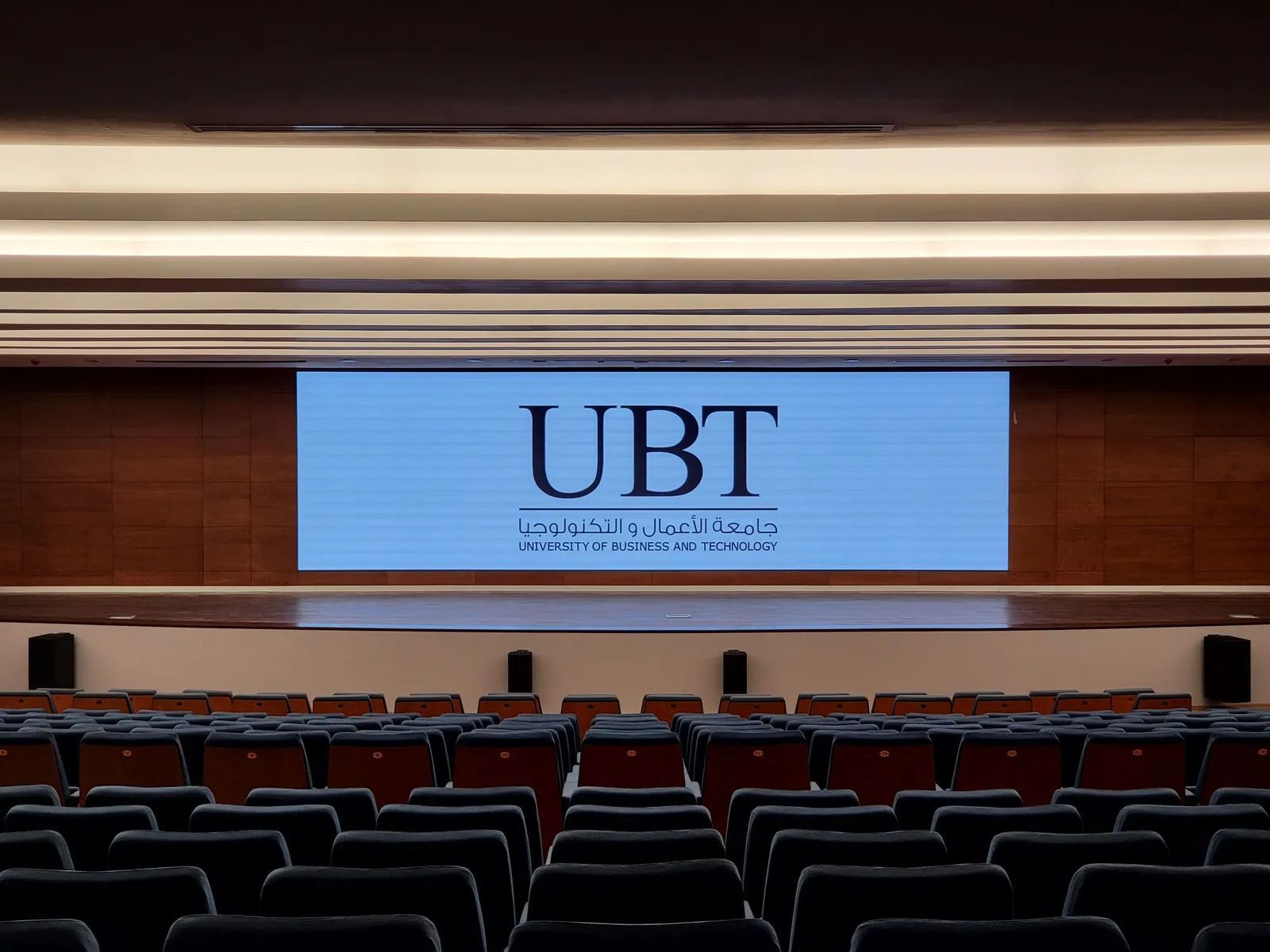 The auditorium LED wall showing the university logo