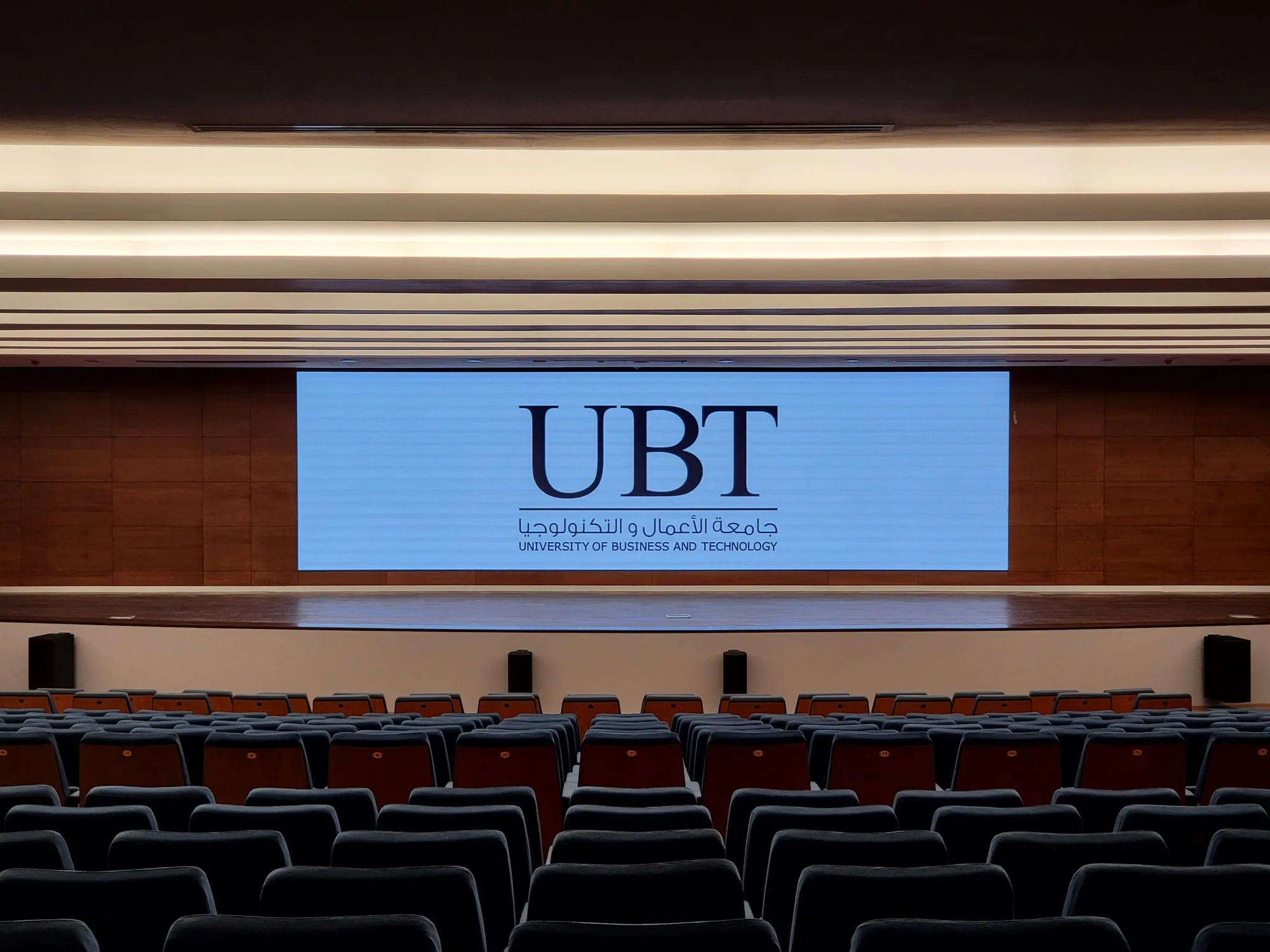 The auditorium LED wall showing the university logo