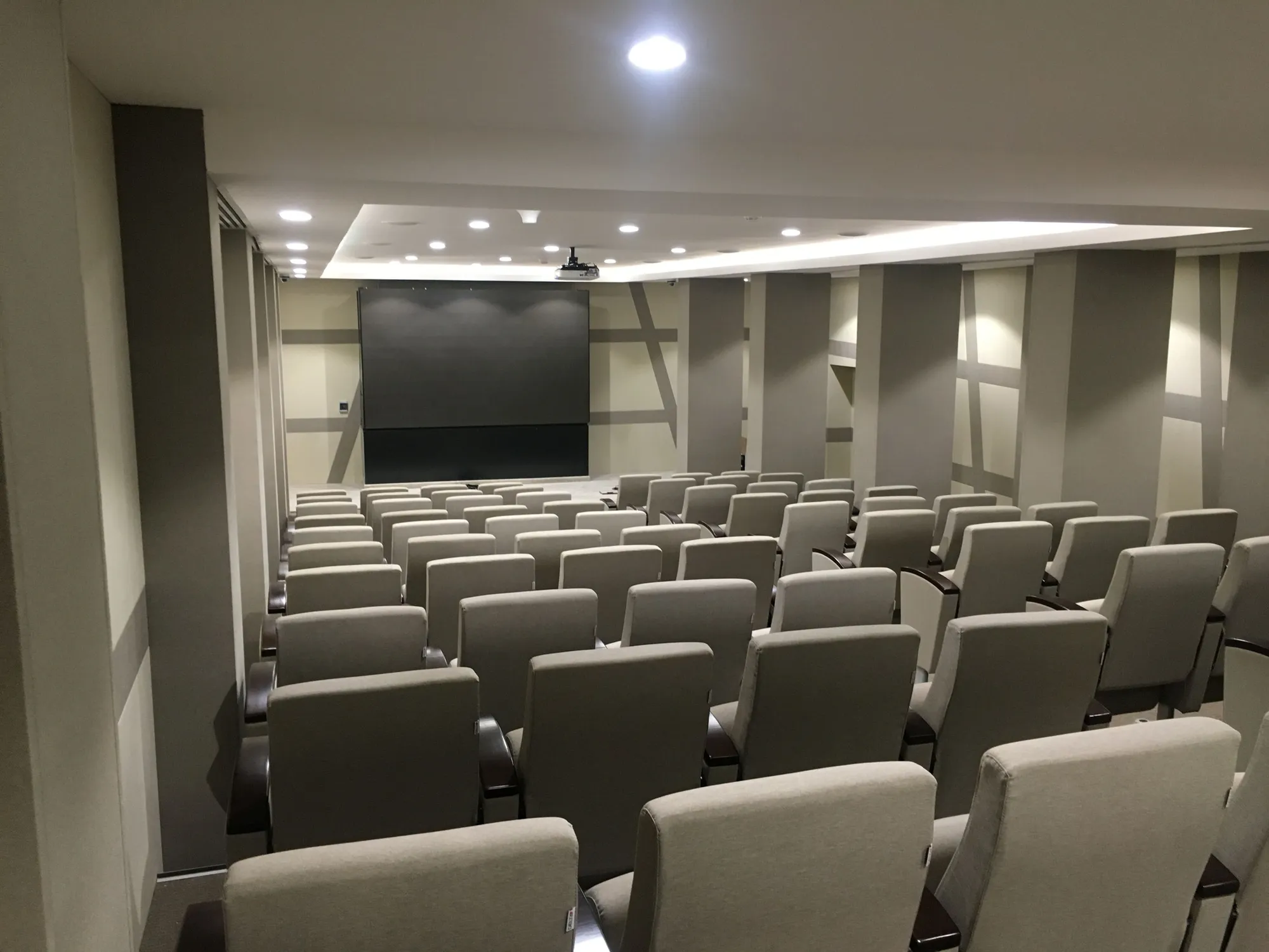 Training room with tiered seating and a projection screen