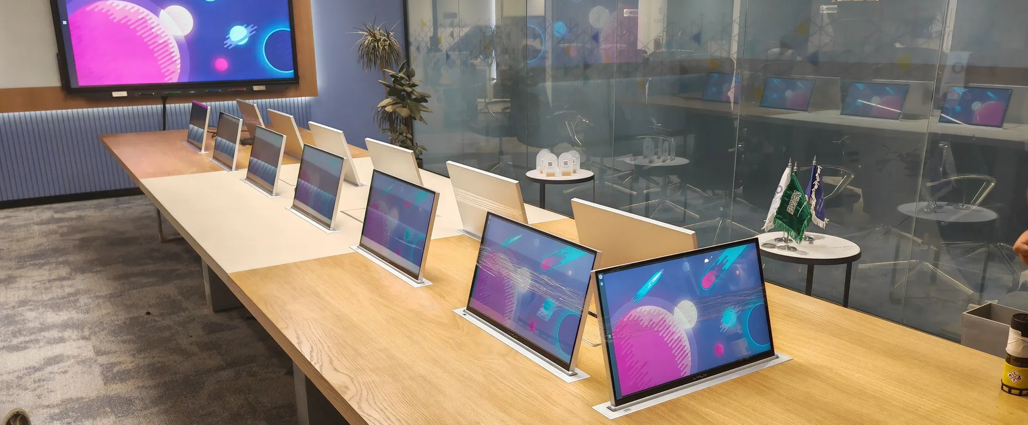 Boardroom table with pop-up monitors at every seat