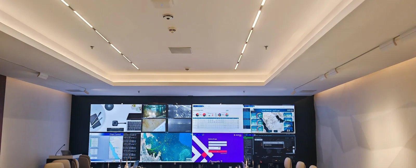 Control room video wall above a long operators' table