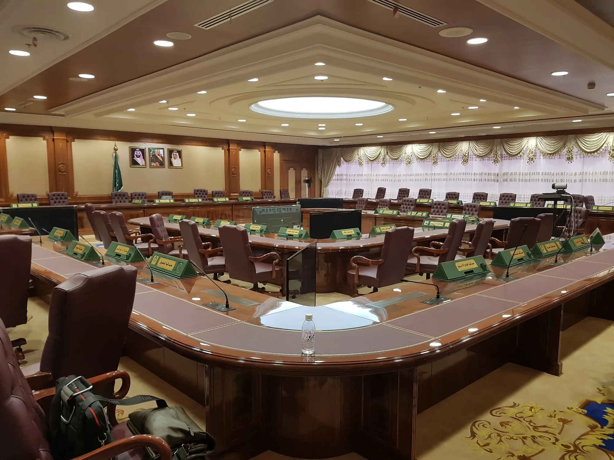 Council chamber with a horseshoe table and delegate microphones