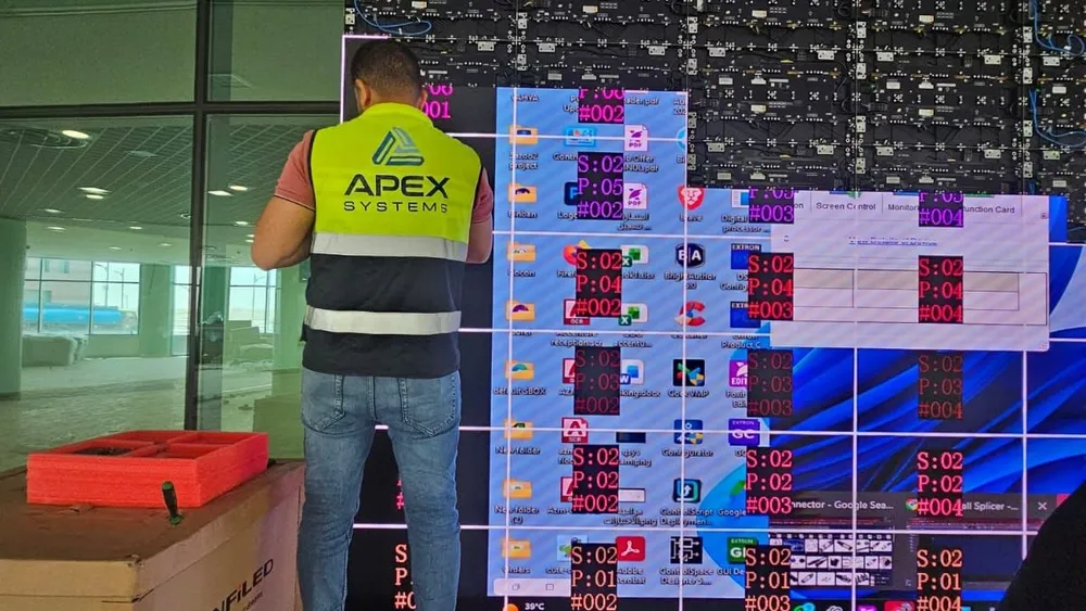 A technician working on the LED wall as it is brought up