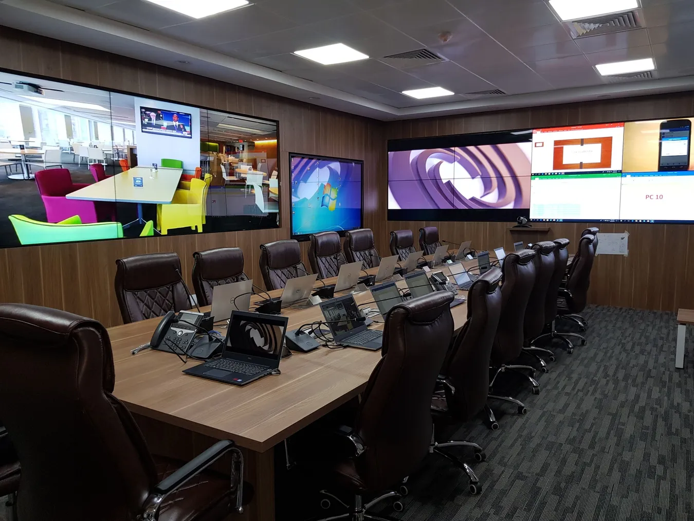 Crisis management room with a video wall above a long discussion table