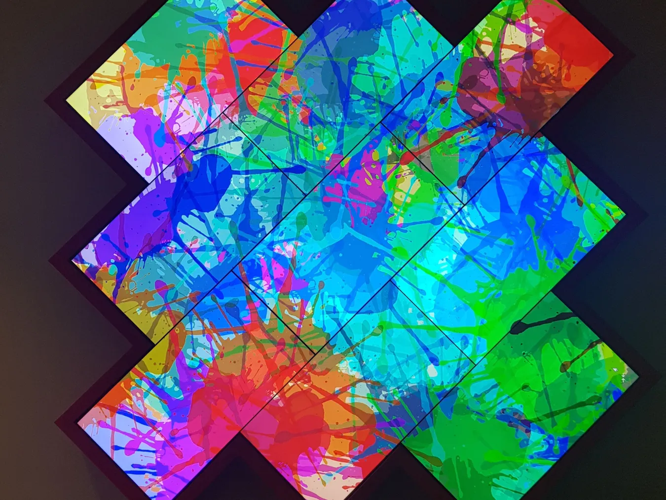 Mosaic video wall of X-shaped LED panels at a college entrance